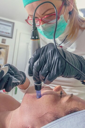 beautician-performs-needle-mesotherapy-treatment-woman-face_559531-41268
